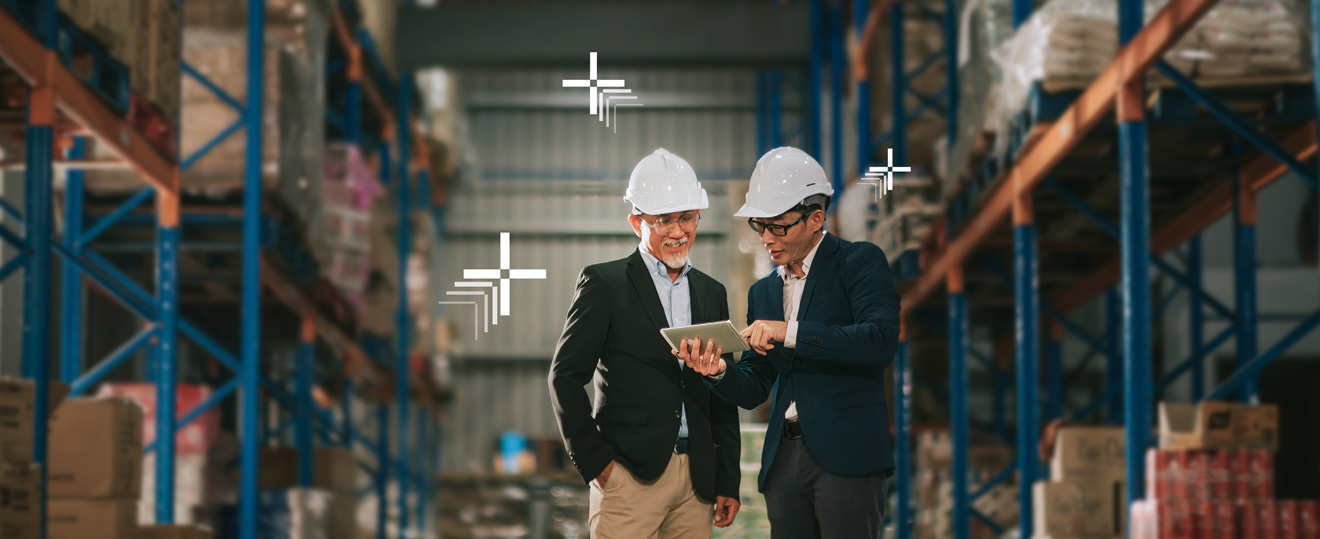 2 business men with hardhats looking at a tablet